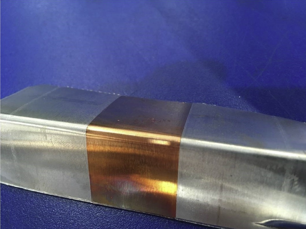 Example of a bend testing coupon of a bi-metallic sample showing a copper inlay within aluminium.